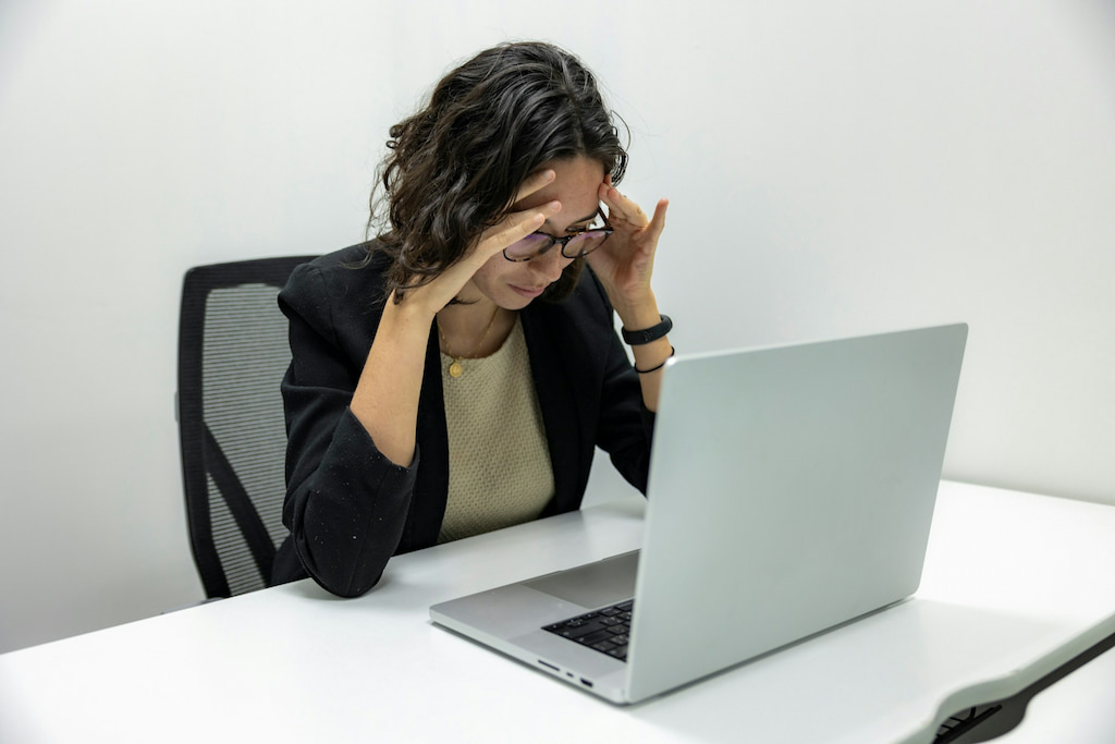 Overwhelmed manager juggling shift requests on paper and email